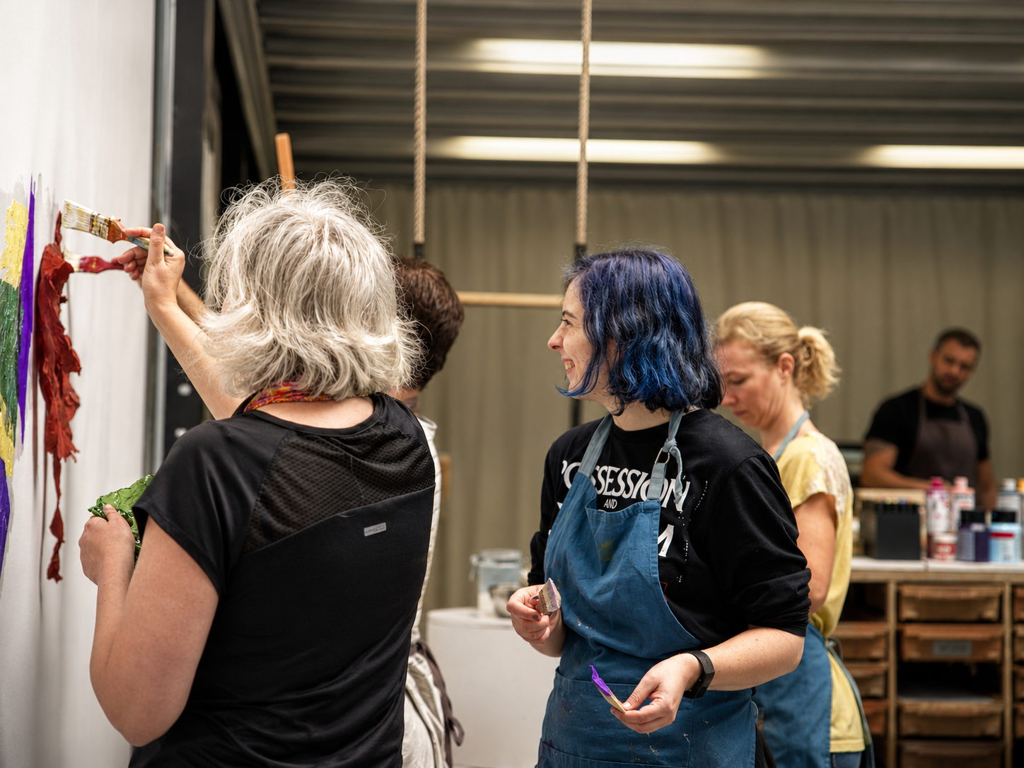 Participants at the KU Leuven Library / PBIB team atelier, painting together on a shared wall.