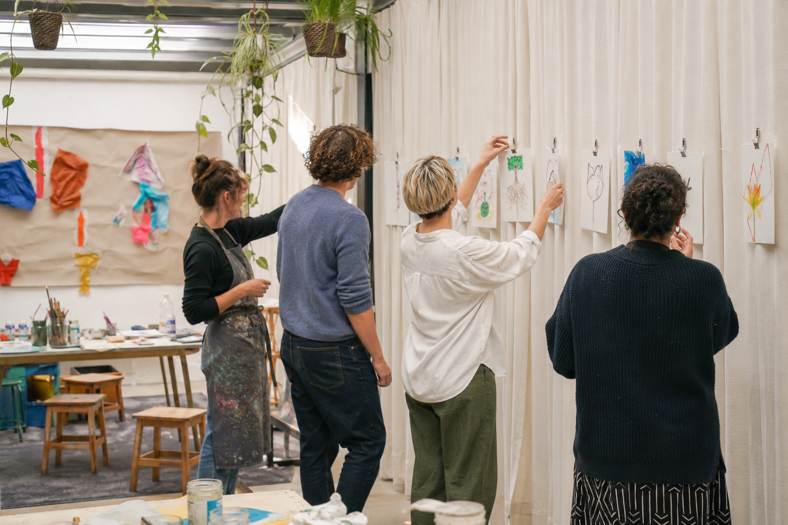 Participants reflecting together on visual work during an artist-led ARTKOM process.