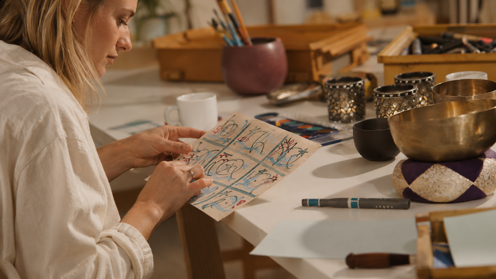 Careful hands working with paper, colour and material: a quiet moment inside the PACT process.