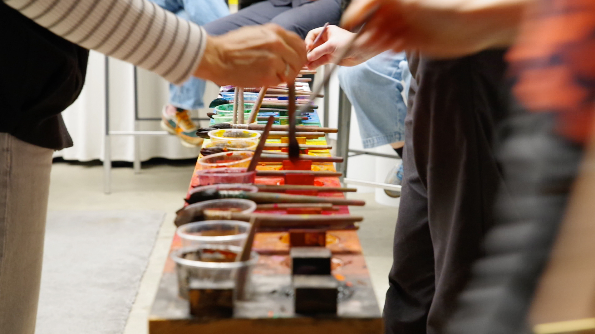 Paints and materials on the shared surface.